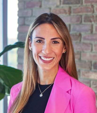Isela Conley, Director of Talent Acquisition at isolved seen in black and pink color combination formal office outfit